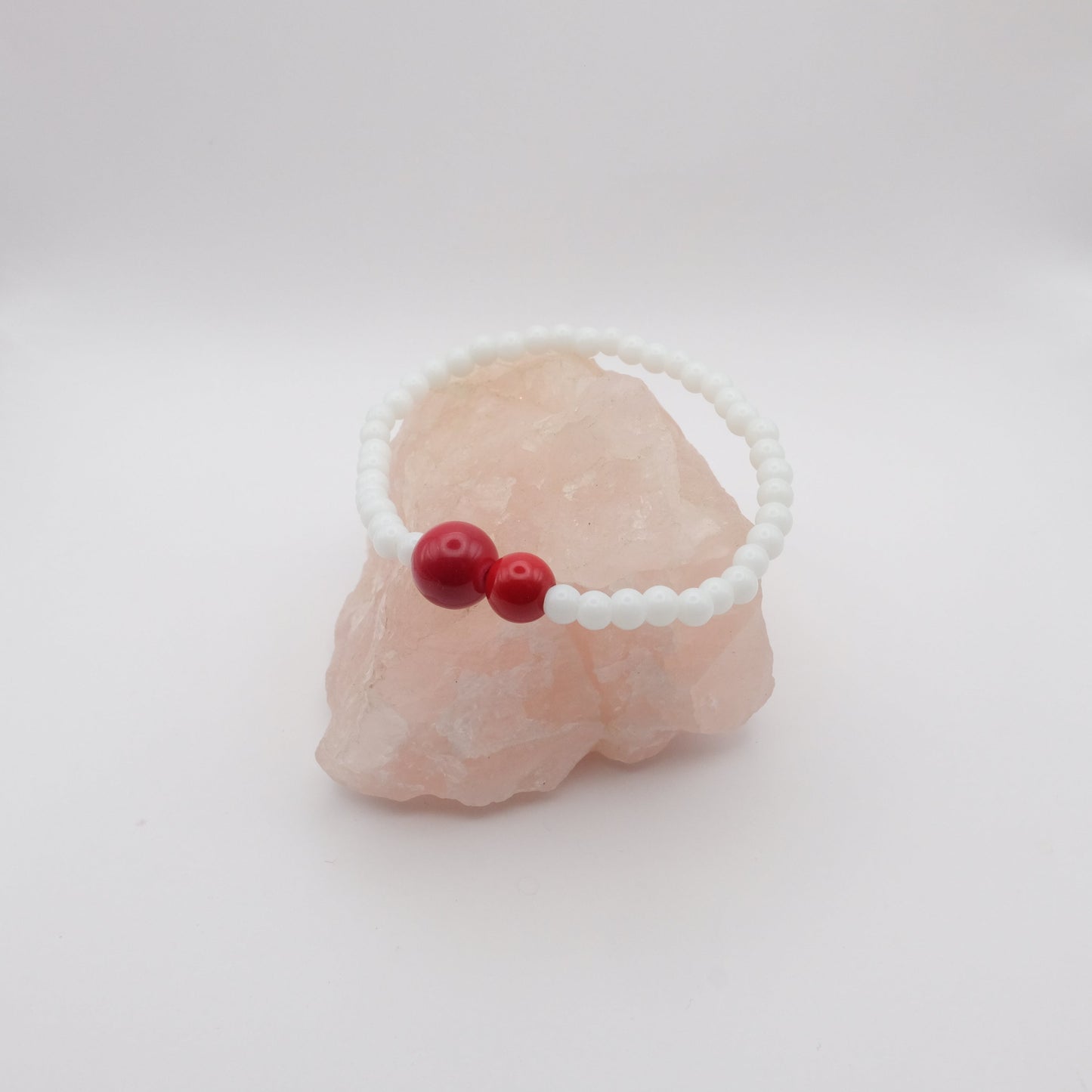 Bracelet with red beads on a white background