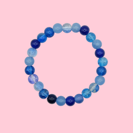 An elastic beaded bracelet composed of 4mm glass beads in varying blue tones - featuring mixed finishes for texture, shown on a white background.