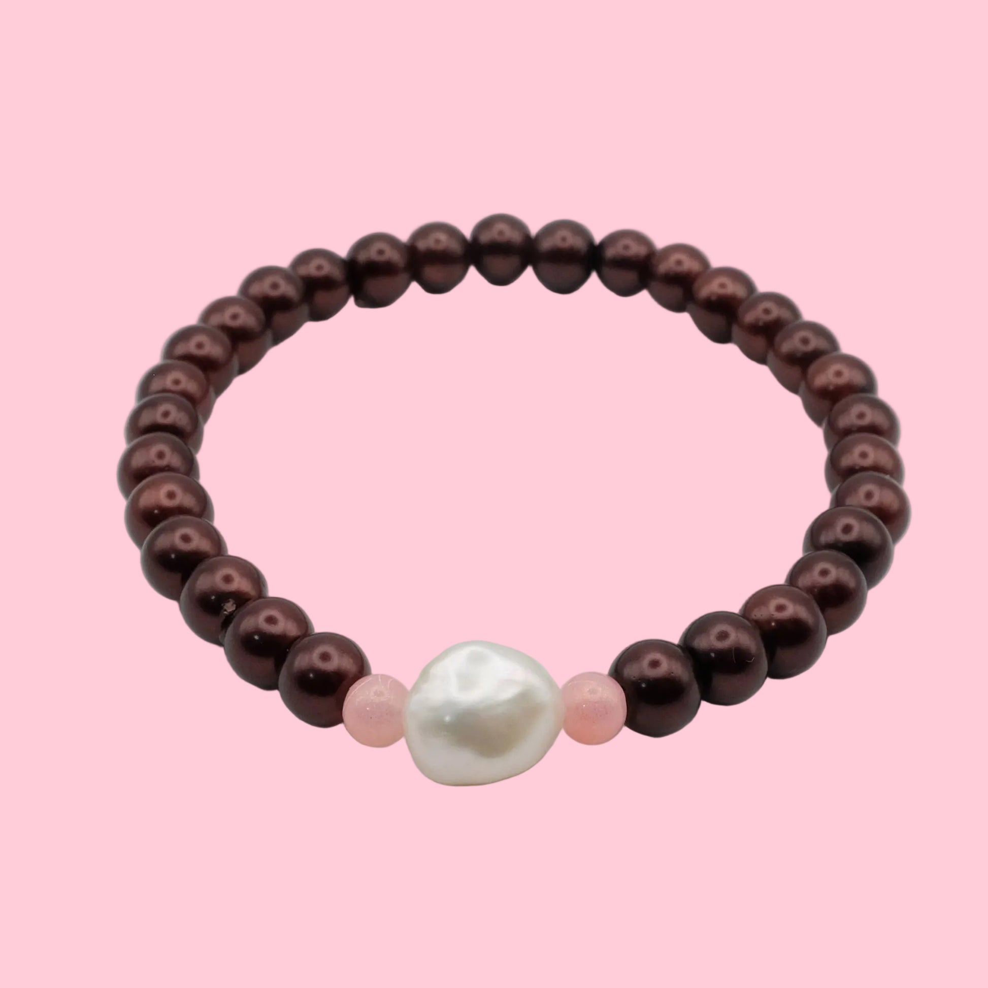 An elastic beaded bracelet composed of metallic burgundy pearl-finish 8mm glass beads featuring a freshwater pearl centrepiece with soft pink accent beads, shown on a white background.
