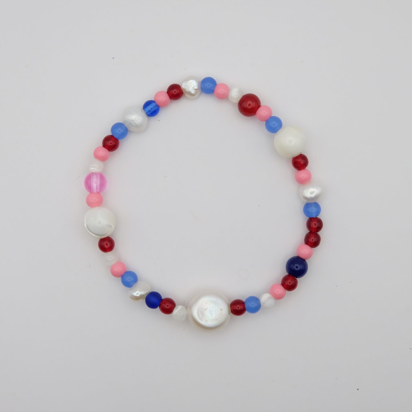 Multicolored beaded bracelet on a light gray background
