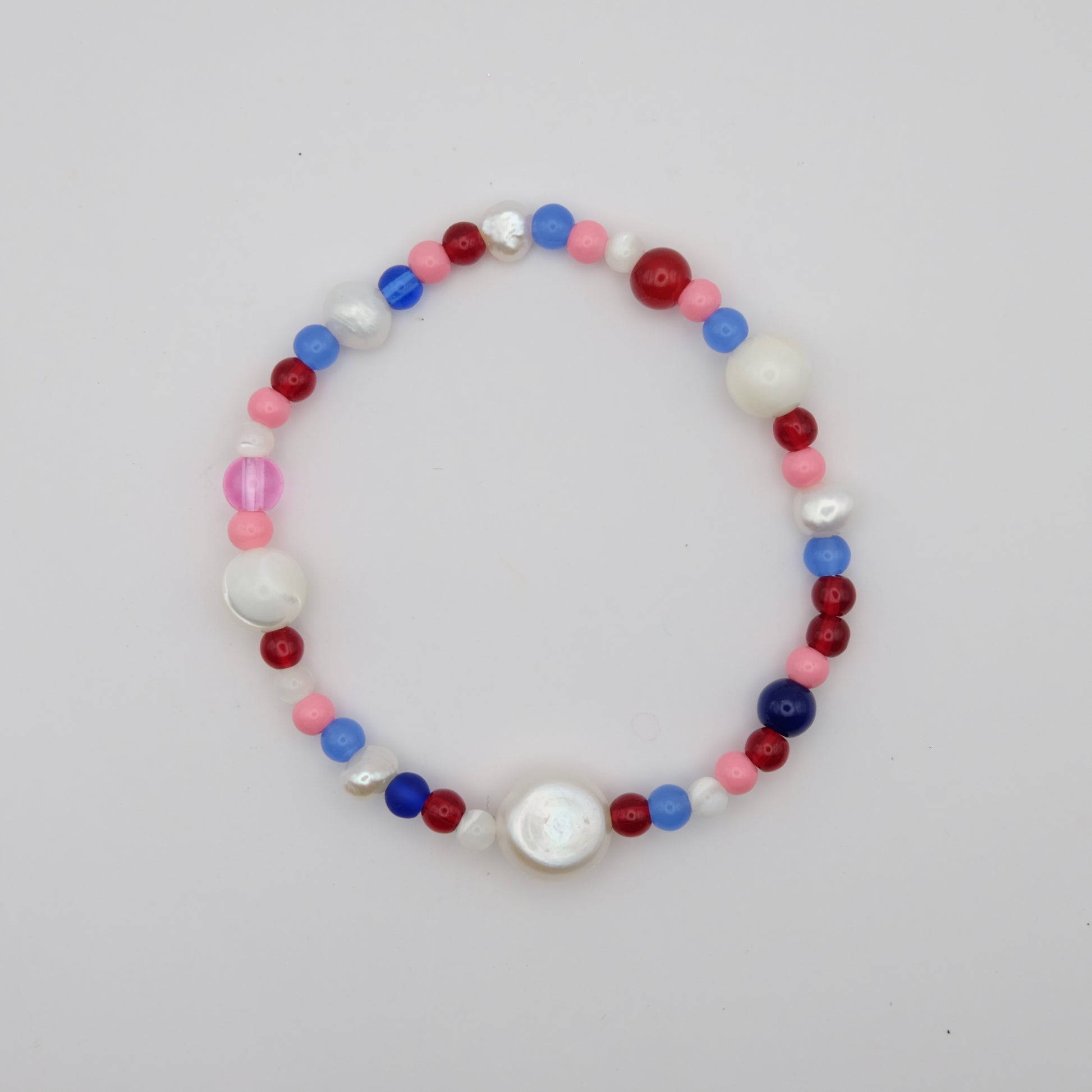 Multicolored beaded bracelet on a light gray background