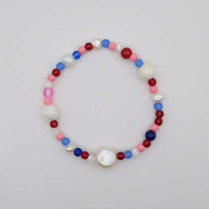 Multicolored beaded bracelet on a light gray background