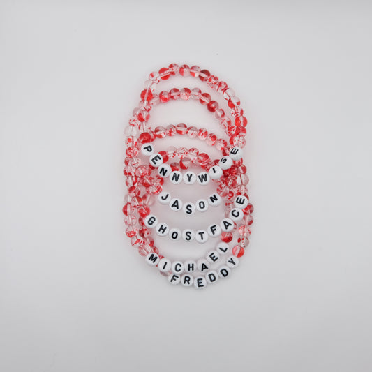 Set of beaded bracelets with letter beads spelling out names on a light gray background