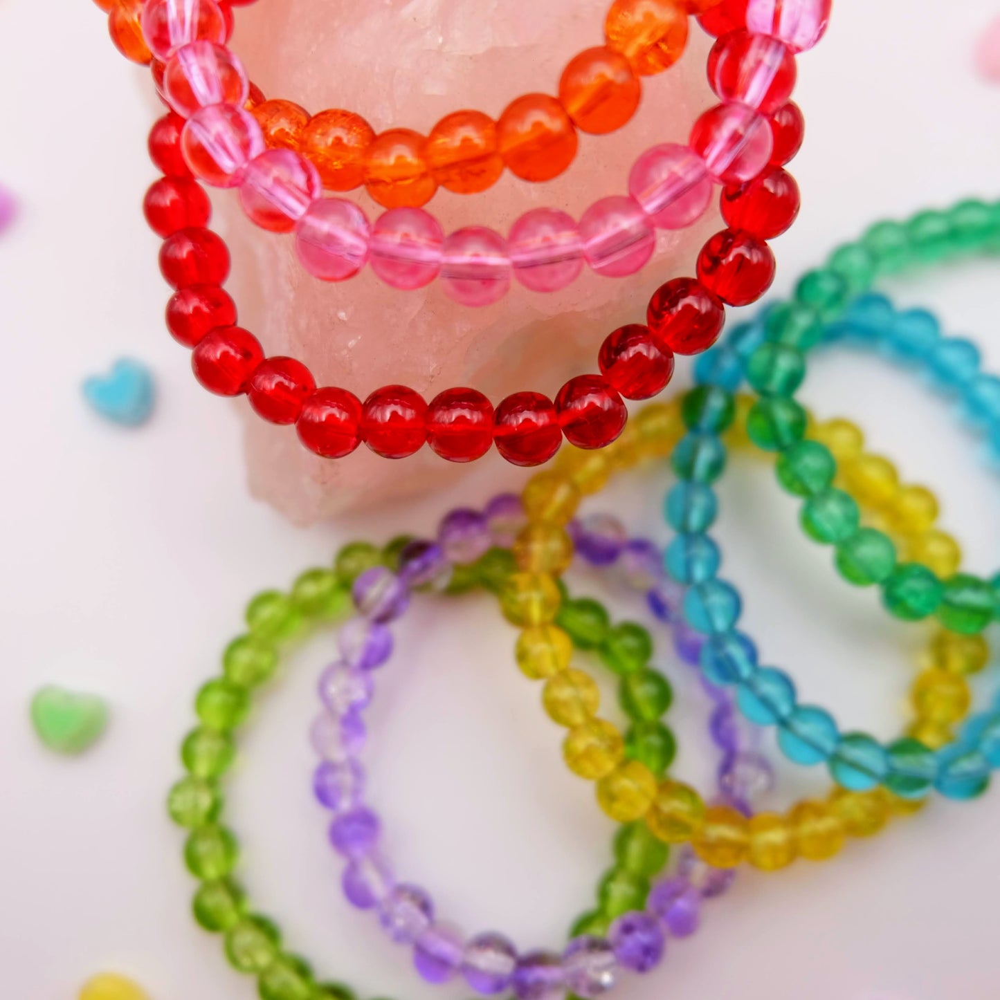 Colorful beaded bracelets on a white background