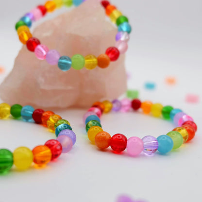 Colorful beaded bracelets on a white background