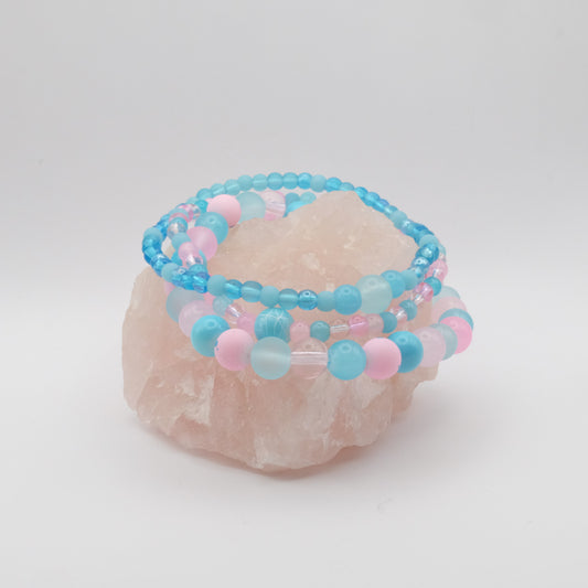 Beaded bracelet with blue and pink beads on a white background