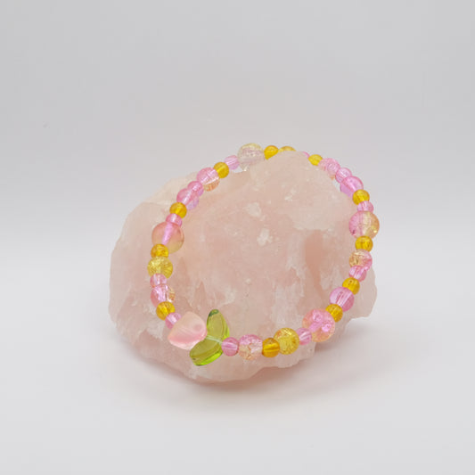 Beaded bracelet with pink and yellow beads on a pink stone