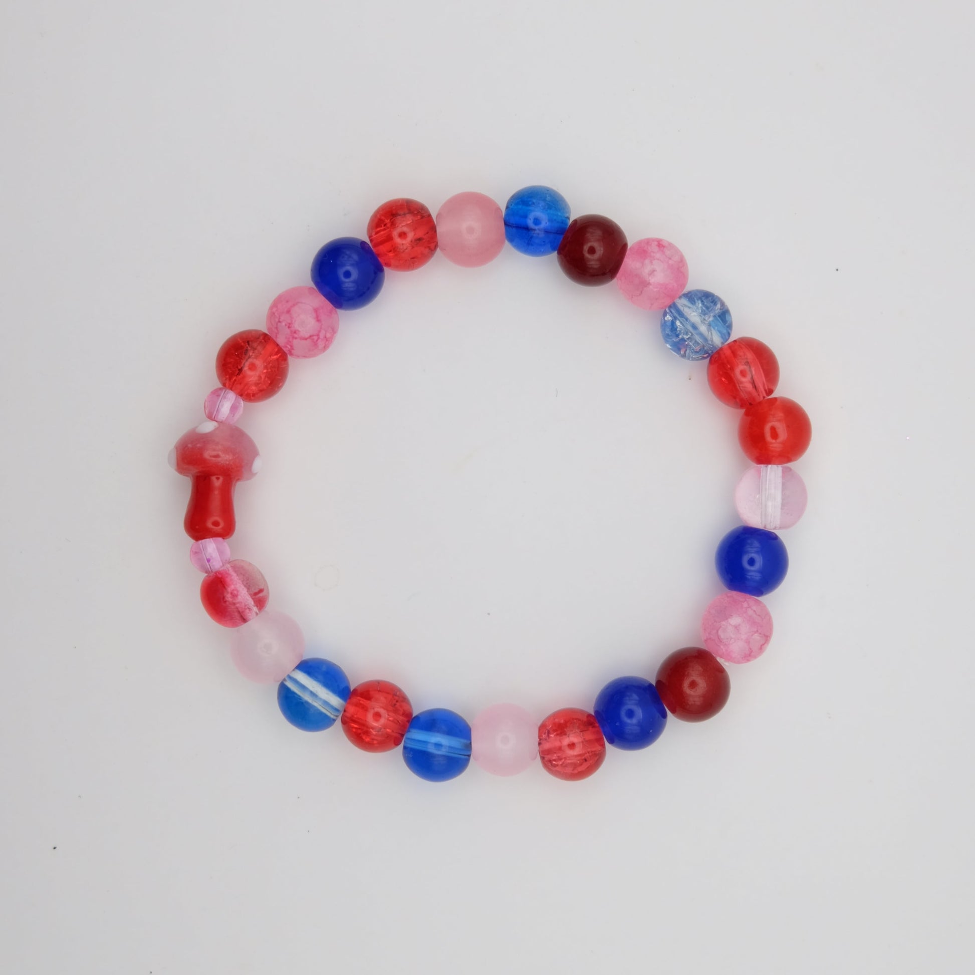 Beaded bracelet with red, blue, and pink beads on a white background