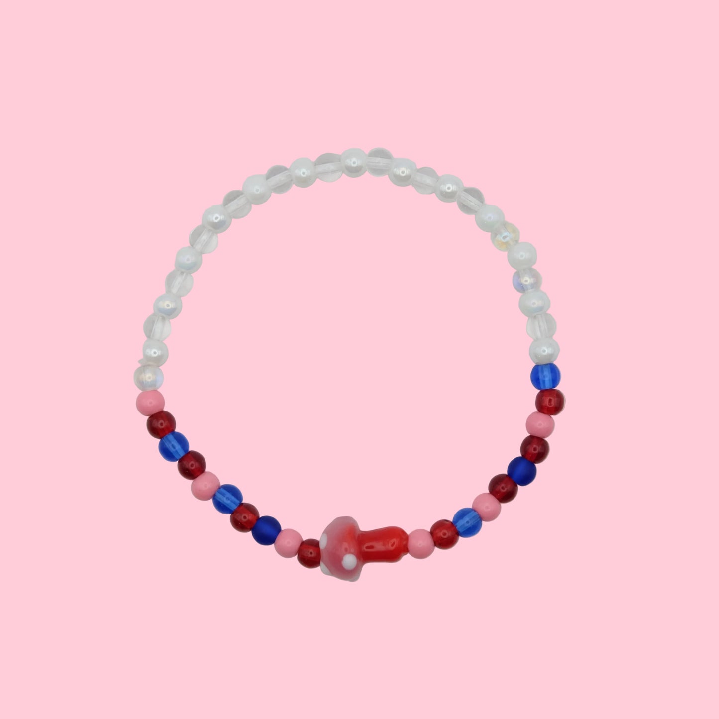 An elastic beaded bracelet made with 4mm glass beads in translucent, whites, red and pink tones, featuring a pink and red blown glass toadstool bead, shown on a white background.