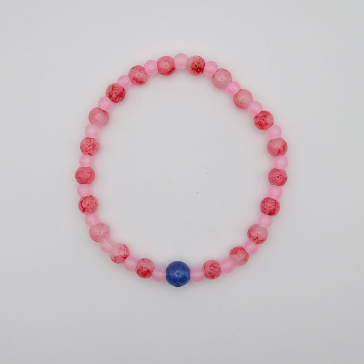 Beaded bracelet with pink and red beads on a white background