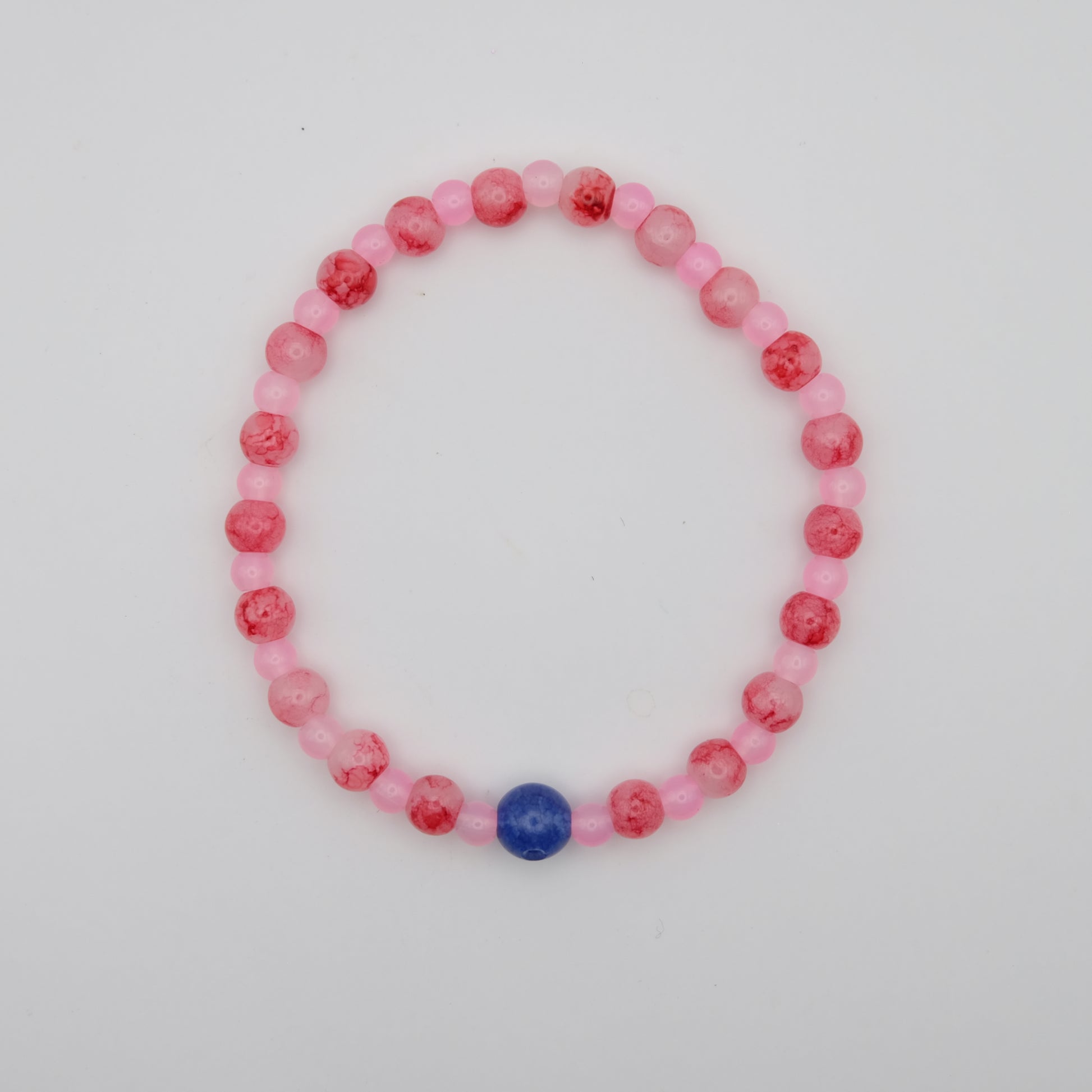 Beaded bracelet with pink and red beads on a white background