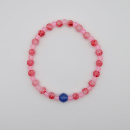Beaded bracelet with pink and red beads on a white background