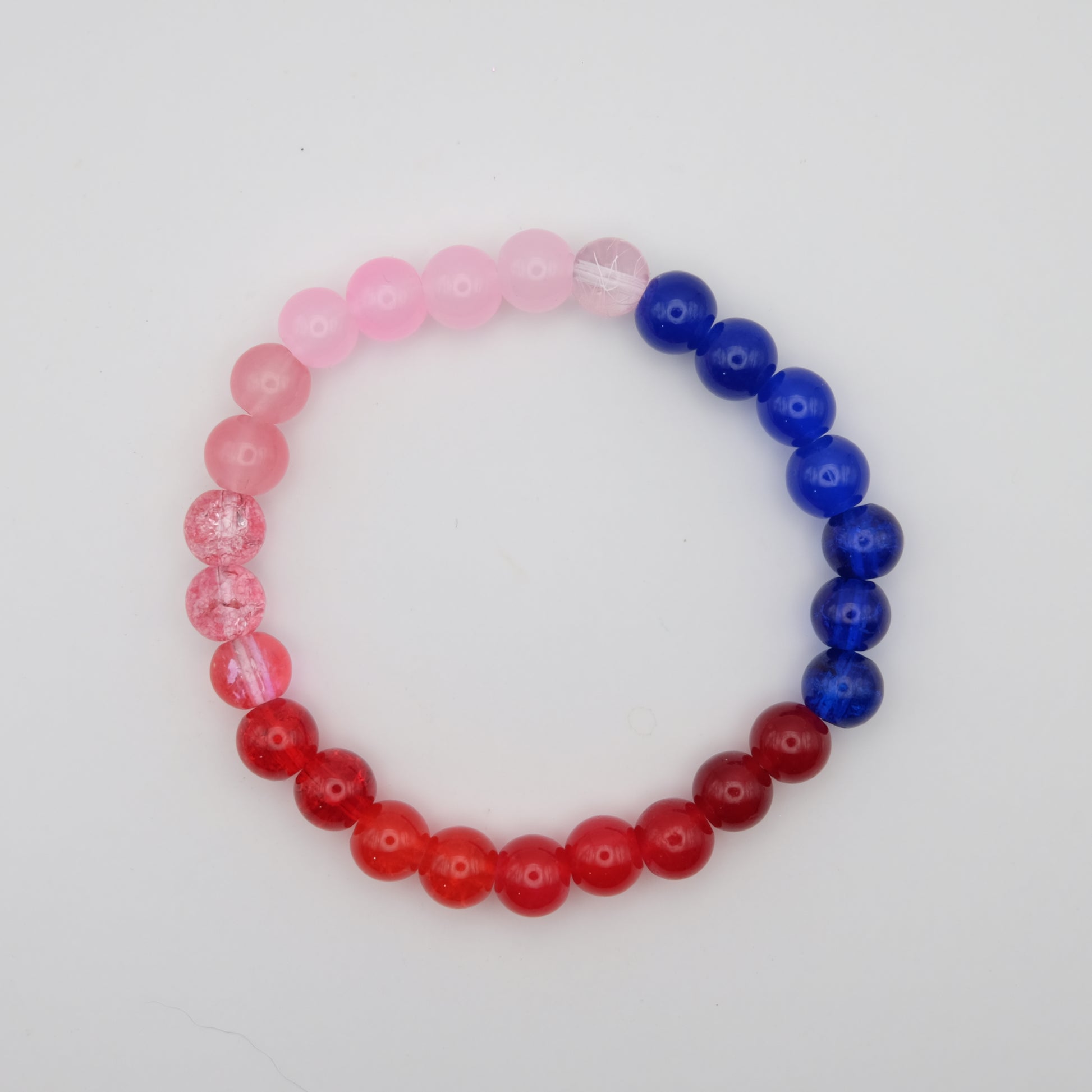 Beaded bracelet with pink, red, and blue beads on a white background