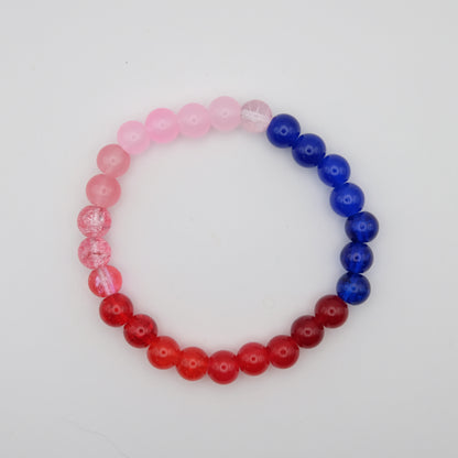 Beaded bracelet with pink, red, and blue beads on a white background