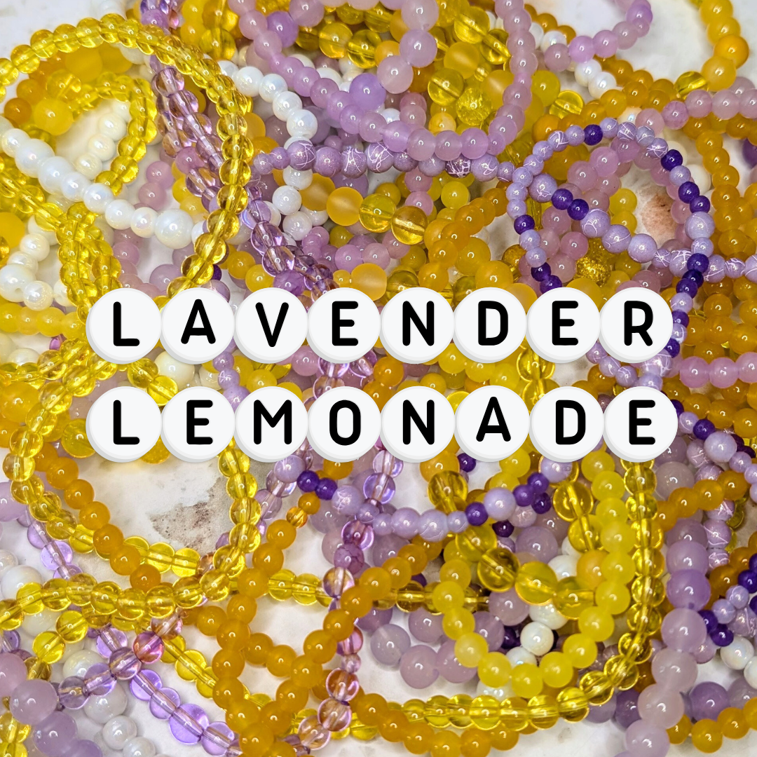 A vibrant mix of elastic beaded bracelets in lavender and lemon tones, crafted with 4mm and 6mm glass beads. “Lavender Lemonade” spelled out in acrylic letter beads. A playful, handmade jewellery collection perfect for dopamine dressing and colourful accessories.