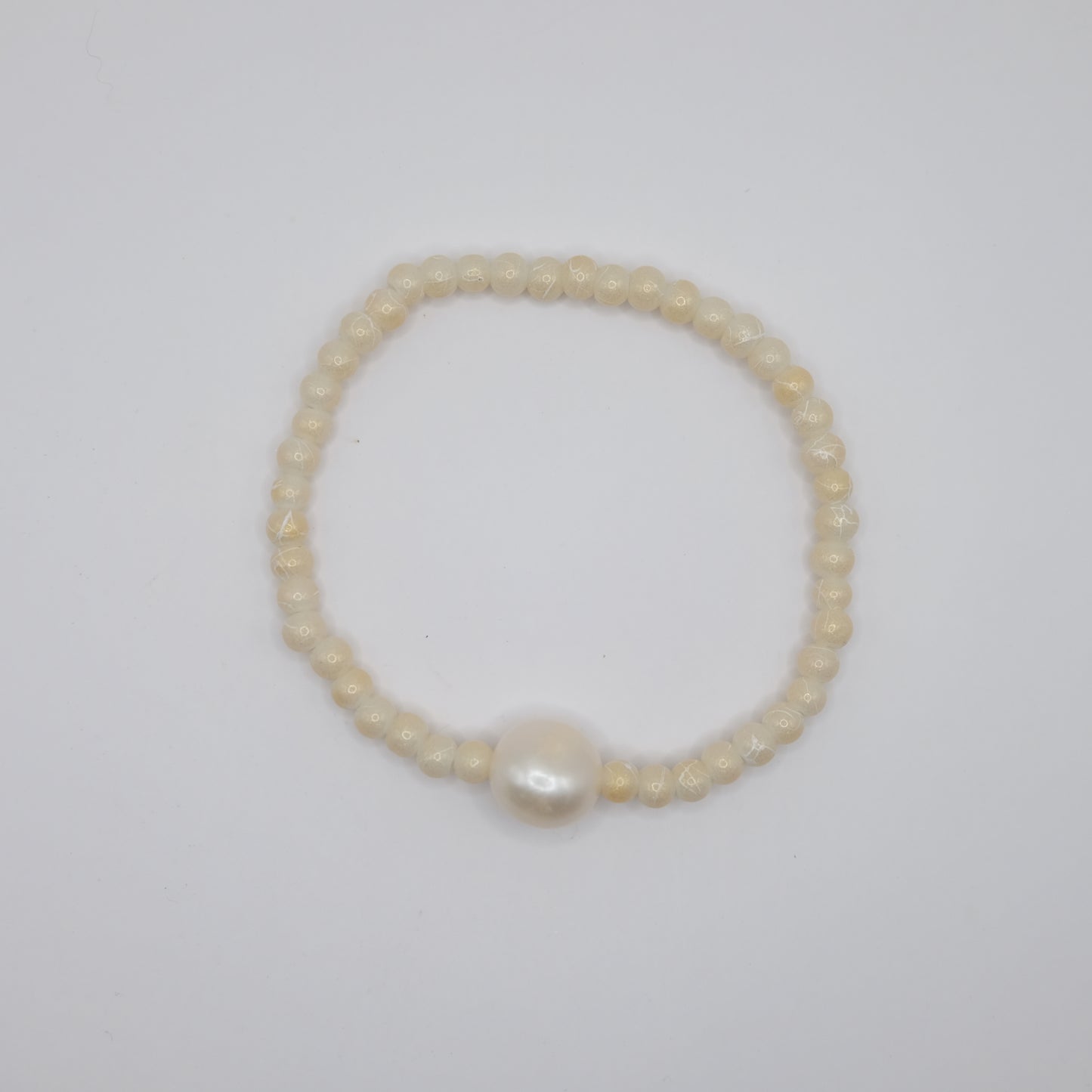Pearl bracelet on a light gray background