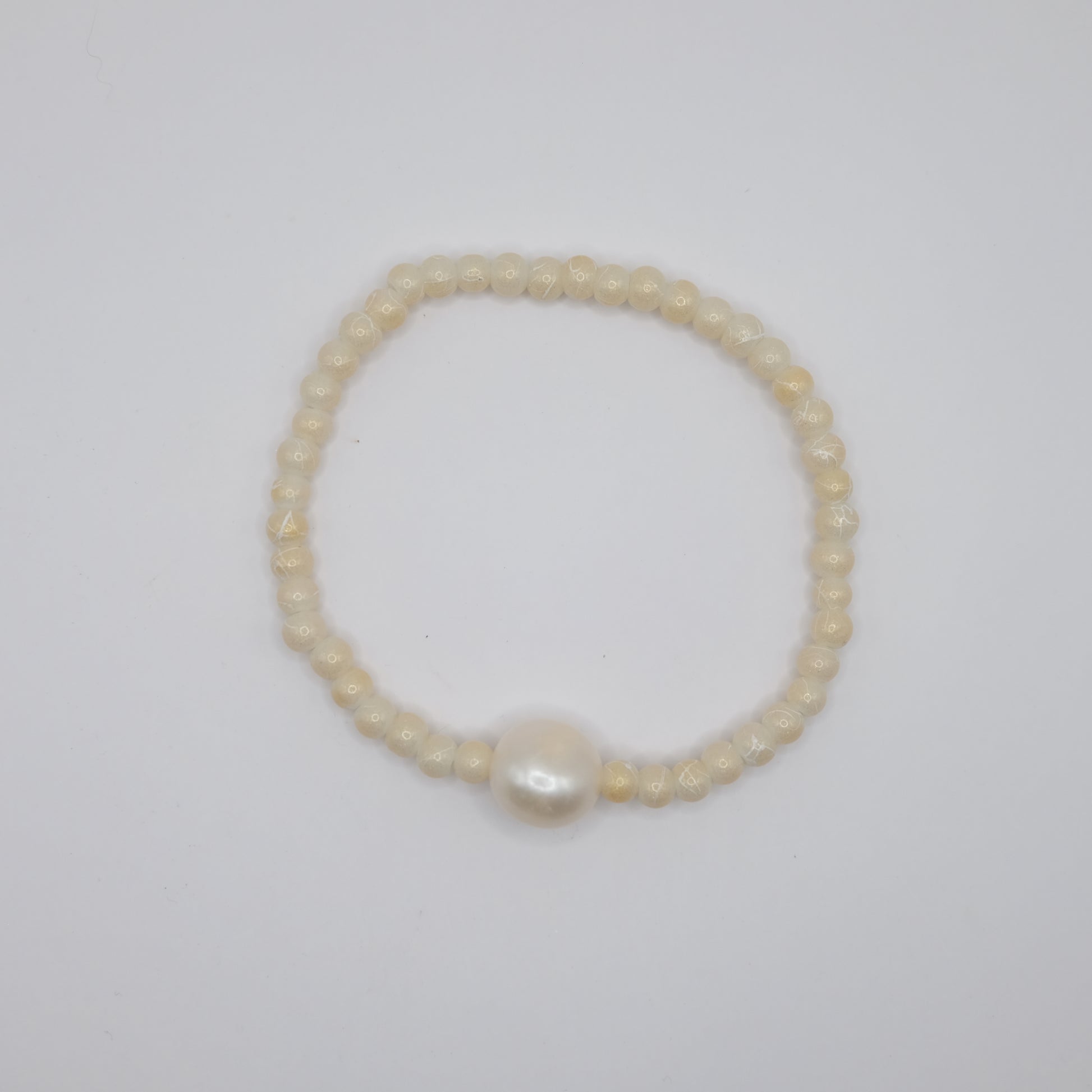Pearl bracelet on a light gray background