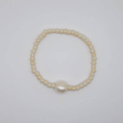 Pearl bracelet on a light gray background