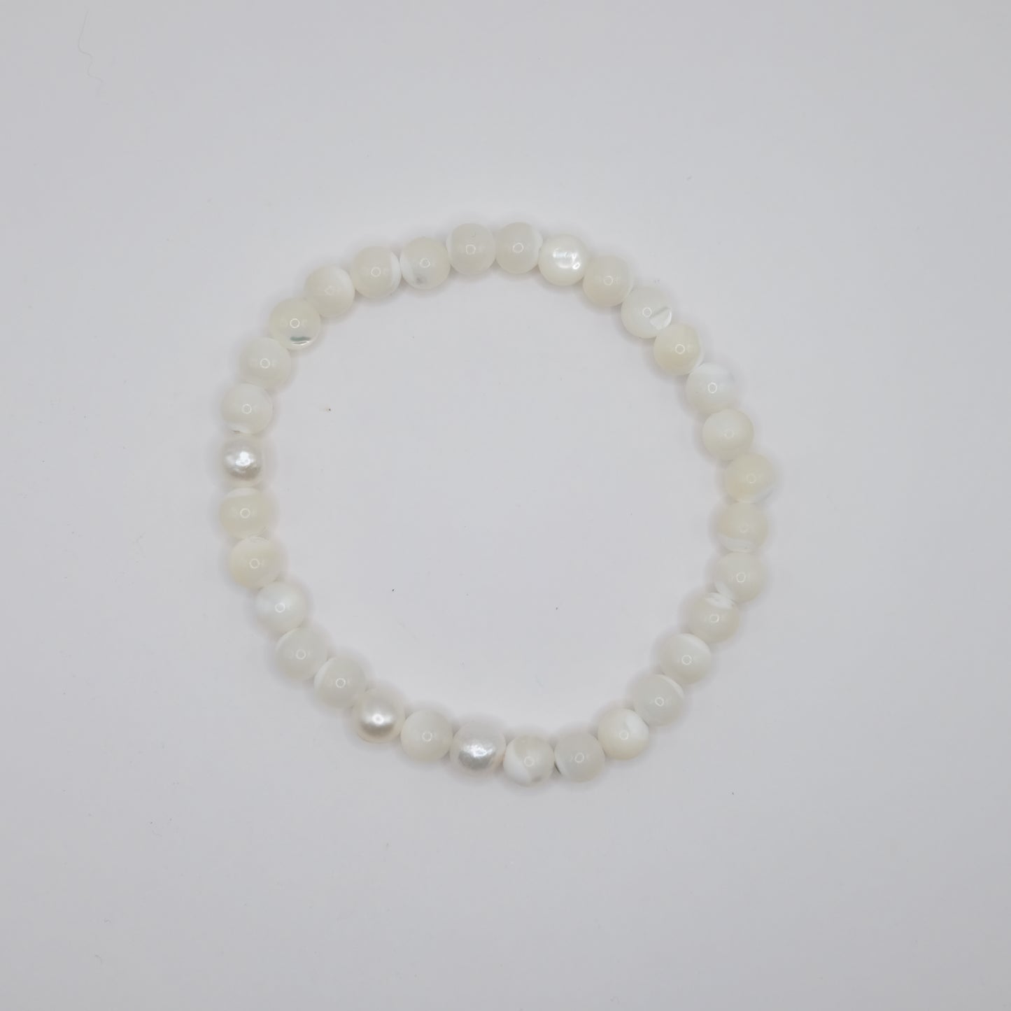 Pearl bracelet on a light gray background