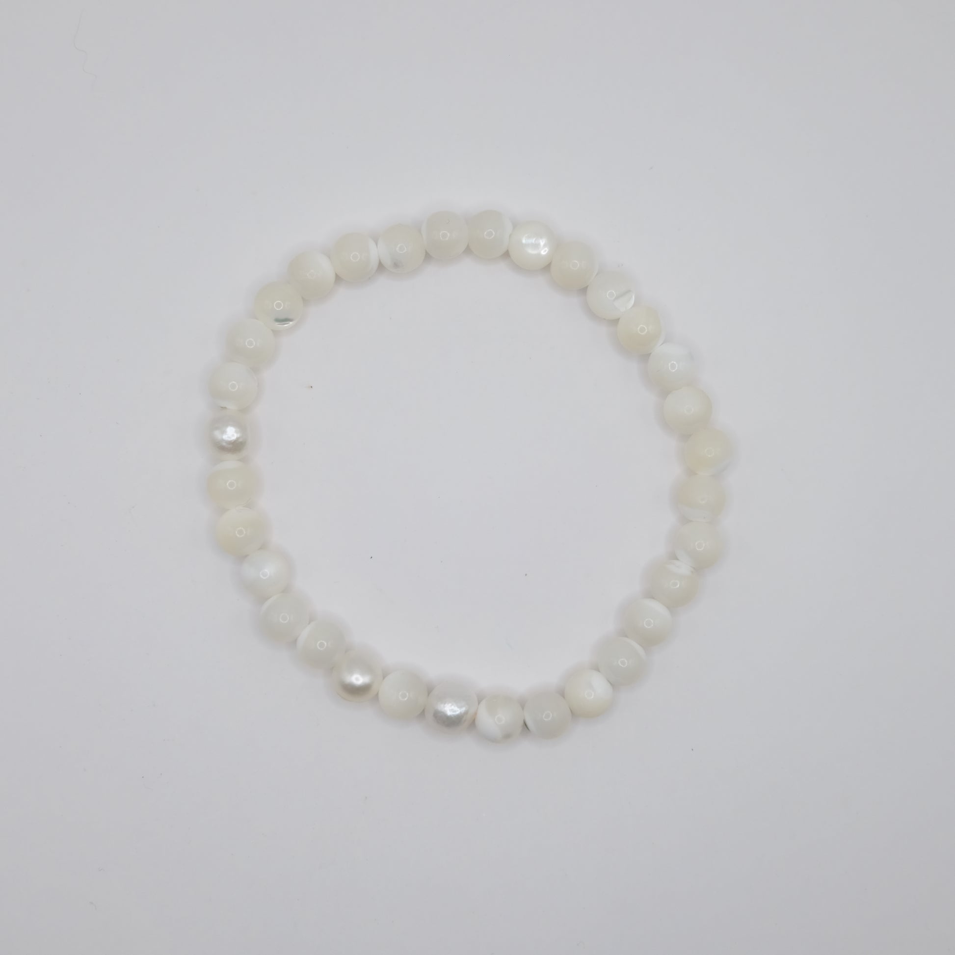 Pearl bracelet on a light gray background
