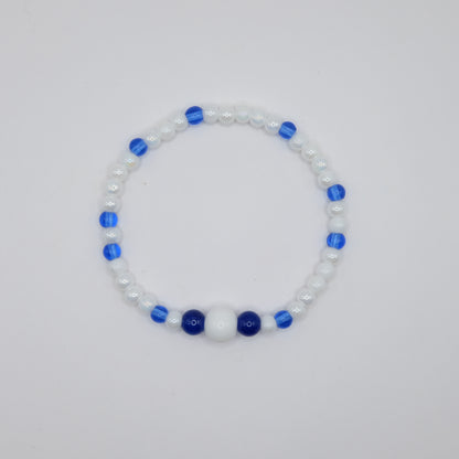 Beaded bracelet with blue and white beads on a light gray background