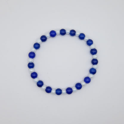 Beaded bracelet with blue and white beads on a light gray background