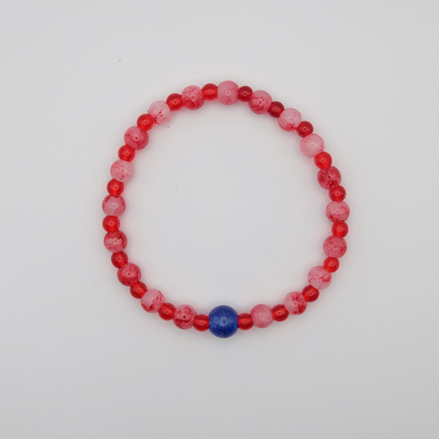 Beaded bracelet with red, pink, and blue beads on a white background