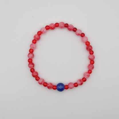 Beaded bracelet with red, pink, and blue beads on a white background