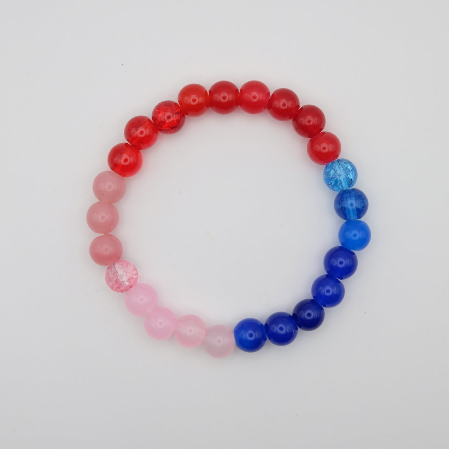 Beaded bracelet with red, pink, and blue beads on a white background