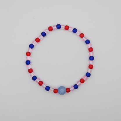 Beaded bracelet with red, blue, and pink beads on a white background