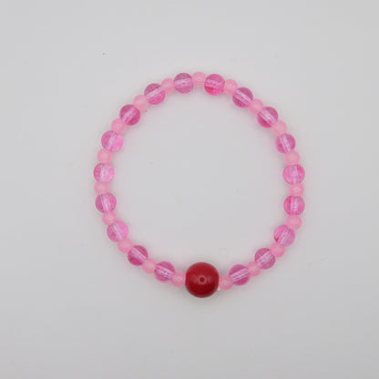 Pink beaded bracelet with a red center bead on a light gray background