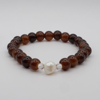 Beaded bracelet with brown and silver beads on a light gray background