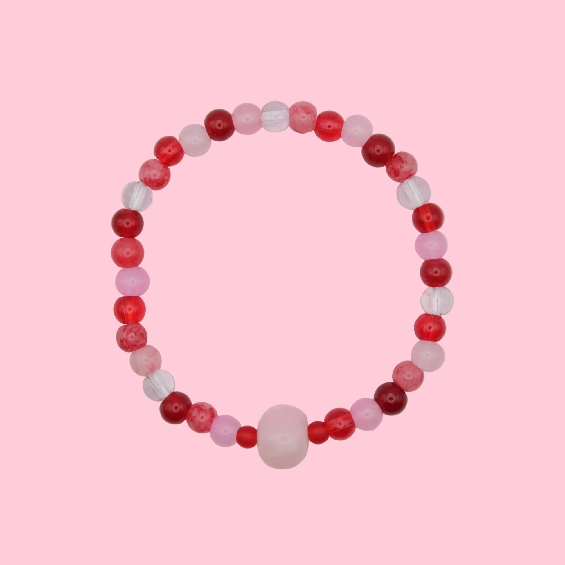 An elastic beaded bracelet composed of 6mm glass beads in pink and red tones - featuring a central pink dyed jade bead framed by smaller glass beads, shown on a white background.