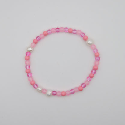 Pink beaded bracelet on a light gray background