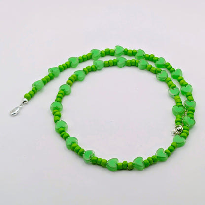 Wendy handmade green beaded necklace featuring vivid green glass beads, translucent green heart beads and silver adjustable hardware.