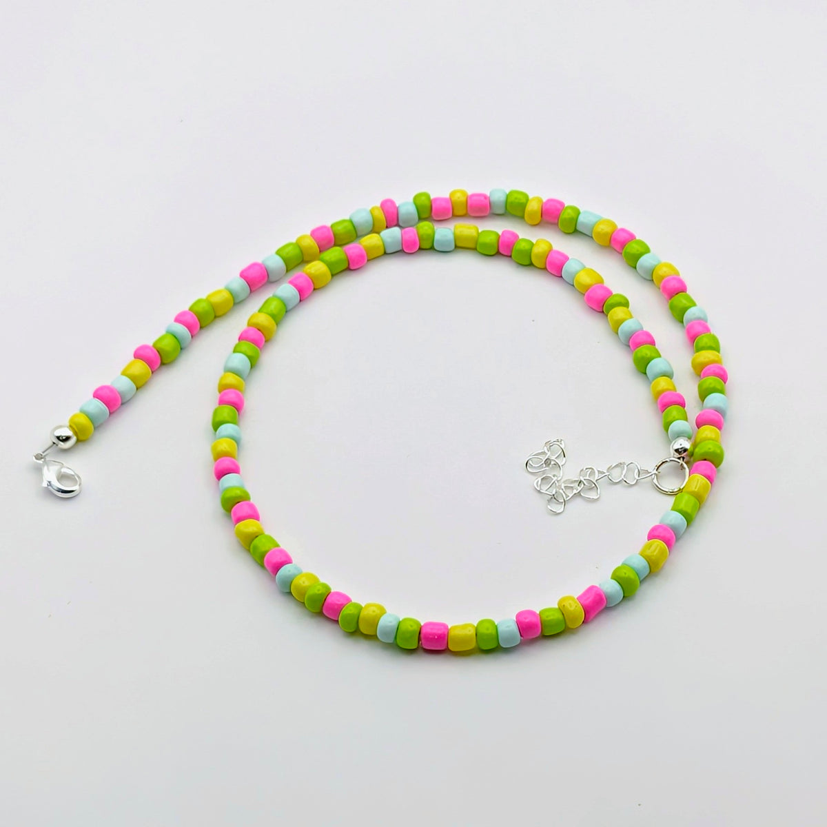 Fran colourful handmade beaded necklace with bright pink, green, aqua and yellow glass beads and silver adjustable hardware.