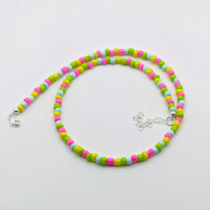 Fran colourful handmade beaded necklace with bright pink, green, aqua and yellow glass beads and silver adjustable hardware.