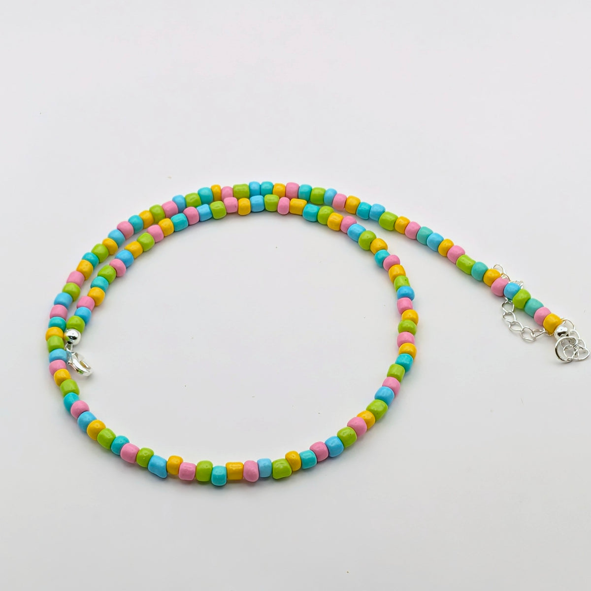 Fran handmade colourful necklace featuring aqua, pink, green and yellow glass beads with silver hardware and adjustable chain.