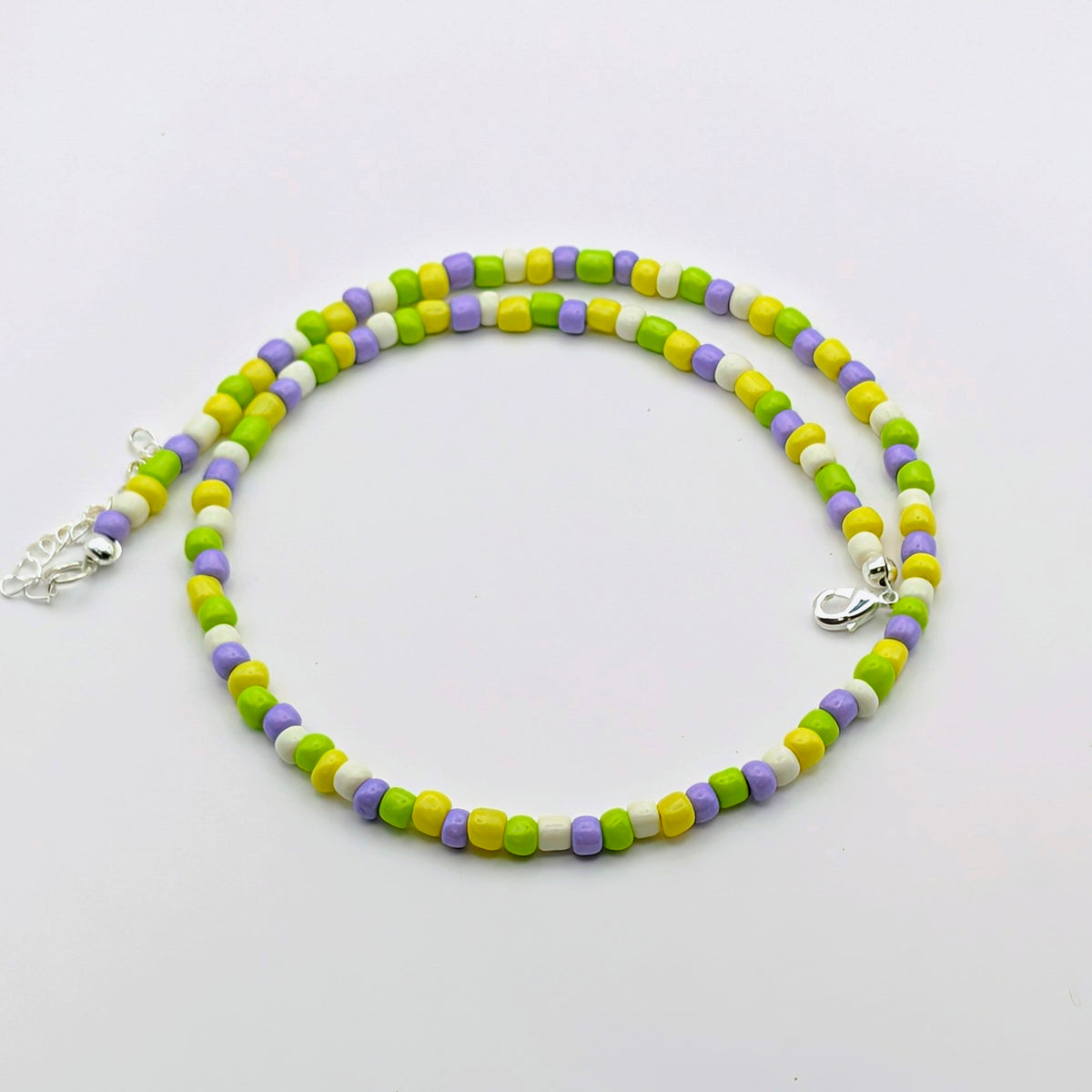 Fran handmade beaded necklace with green, yellow, lilac and white glass beads, finished with silver clasp and extension chain.