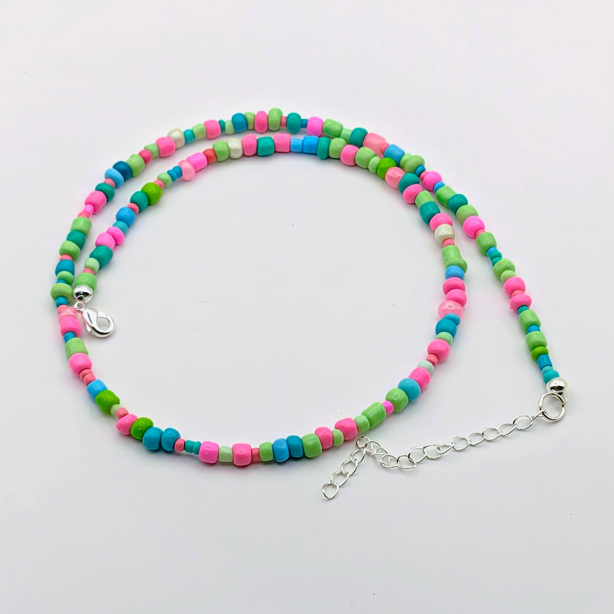 Janice colourful handmade beaded necklace with bright pink, green and blue glass beads and silver adjustable clasp by Velveteen Sunshine.