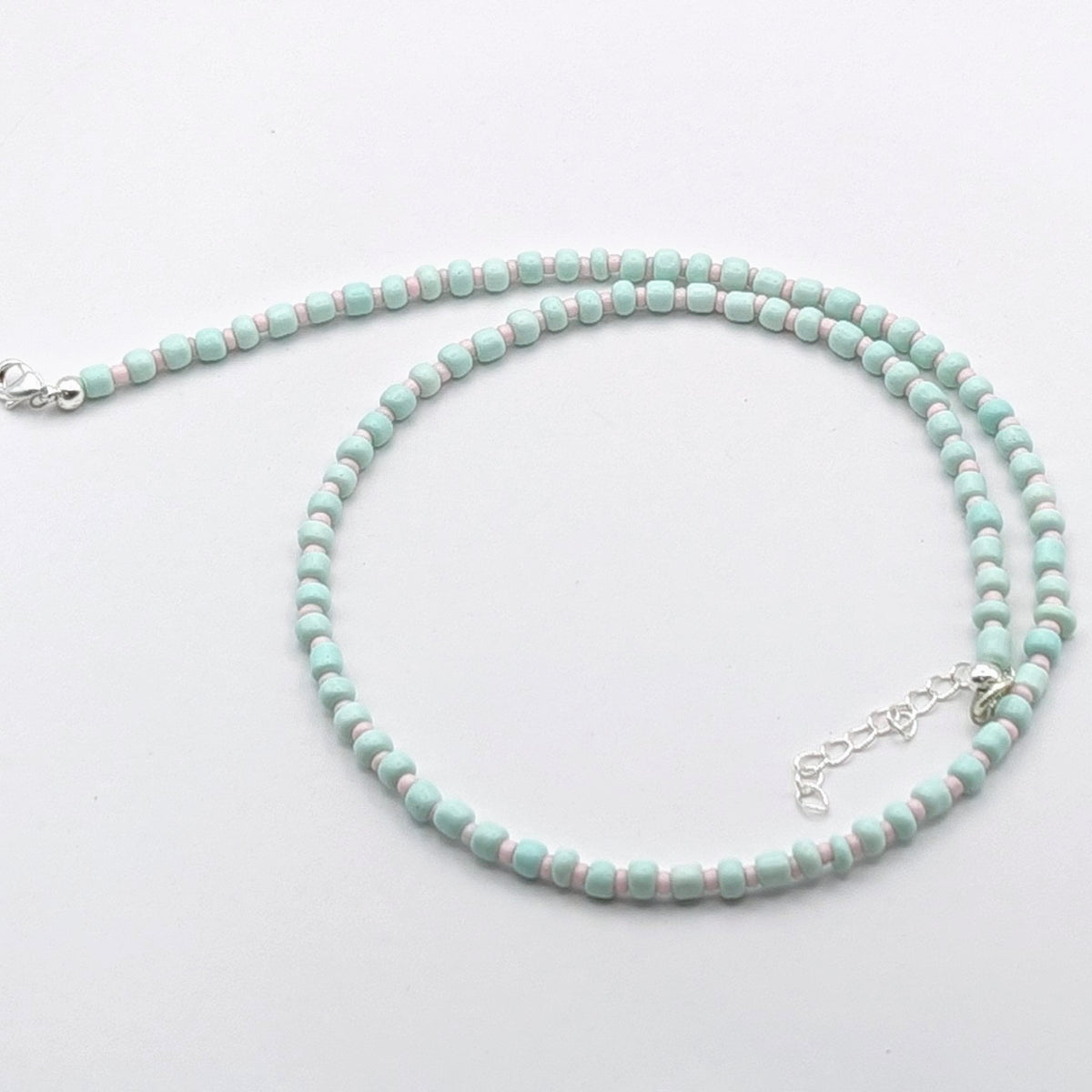 Bianca handmade beaded necklace with mint green glass beads, pale pink accent beads and silver adjustable clasp, handmade by Velveteen Sunshine.