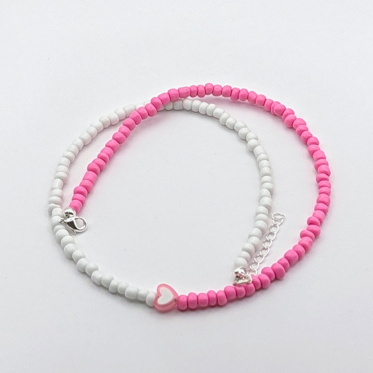 Sara colourful handmade necklace with pink and white glass beads, pink and white heart bead and silver adjustable hardware.