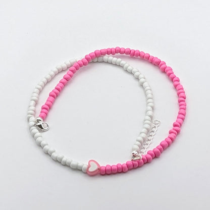 Sara colourful handmade necklace with pink and white glass beads, pink and white heart bead and silver adjustable hardware.