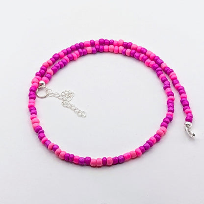 Fran handmade beaded necklace with alternating bright pink and purple glass beads, finished with silver clasp and extension chain.