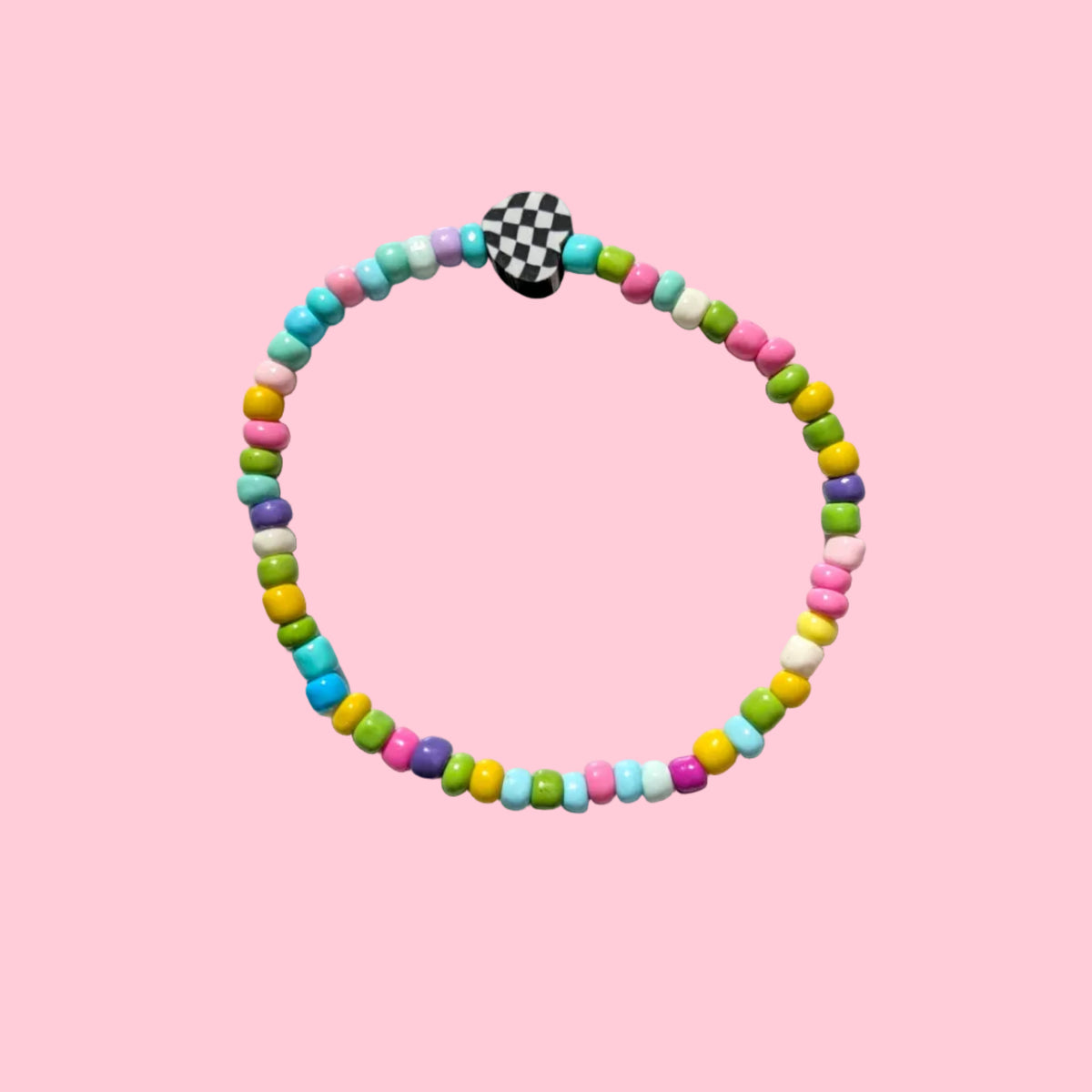 A beaded stretch bracelet with pastel-colored cylindrical beads and a black-and-white checkered clasp, displayed on a textured white background.