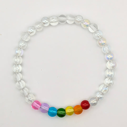 Maisie handmade bracelet by Velveteen Sunshine, featuring clear 6mm glass beads with a small rainbow section on a white background.