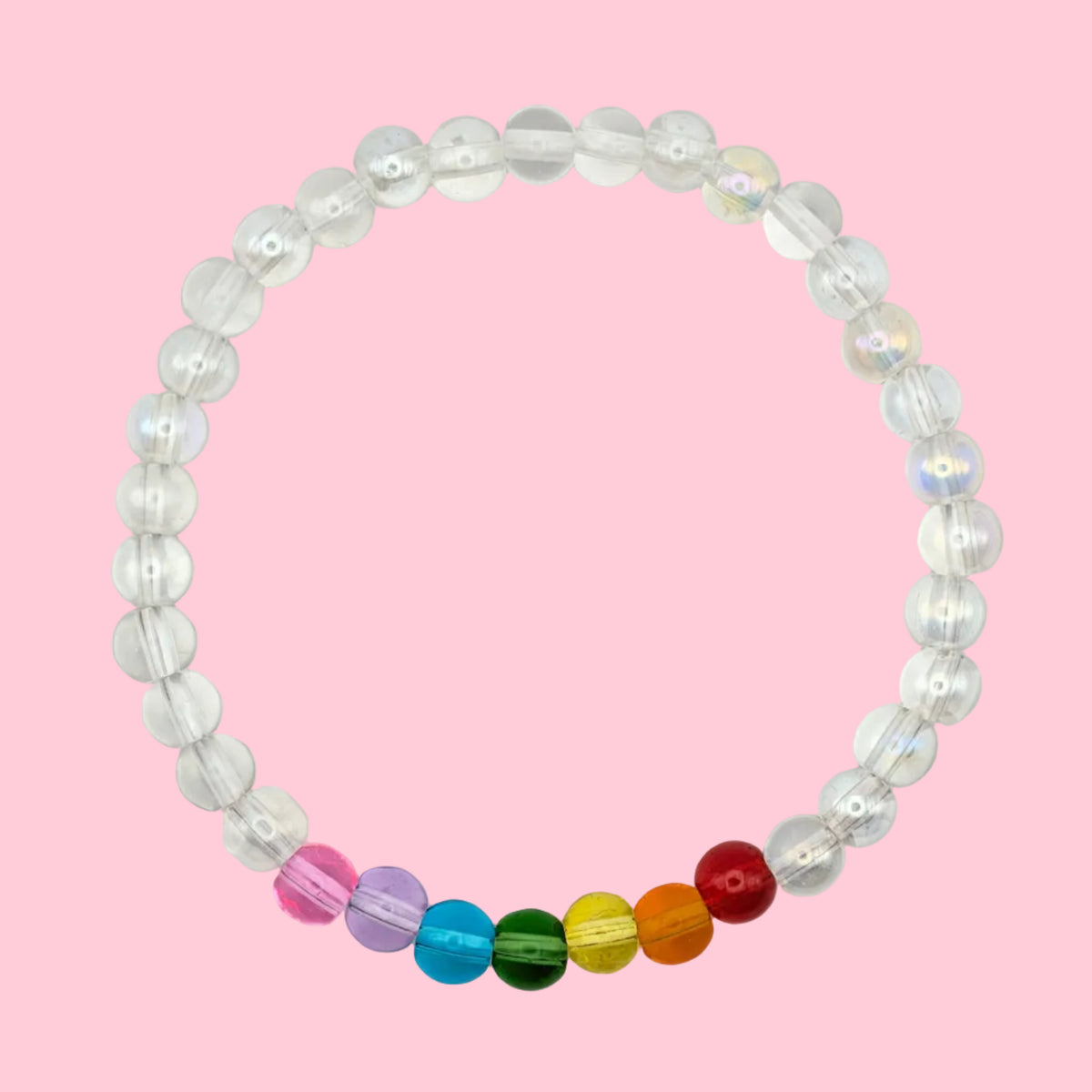Maisie handmade bracelet by Velveteen Sunshine, featuring clear 6mm glass beads with a small rainbow section on a pink background.