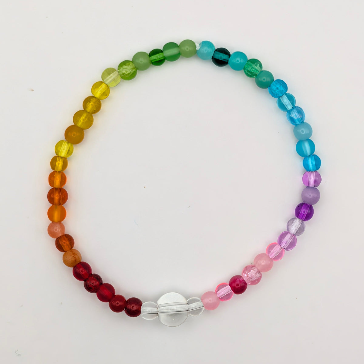 Lola bracelet in Jellybean by Velveteen Sunshine, featuring rainbow glass beads and a large clear feature bead on a white background.