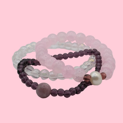 One-of-a-kind bracelet stack featuring blush pink glass beads, clear crystal beads, freshwater pearls and soft plum accents from the Satin Static collection.