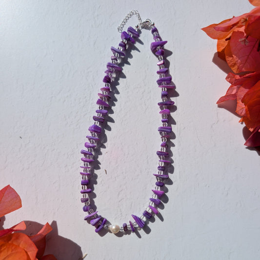Handmade purple beaded necklace with dyed shell chip beads, clear glass beads and a single freshwater pearl.